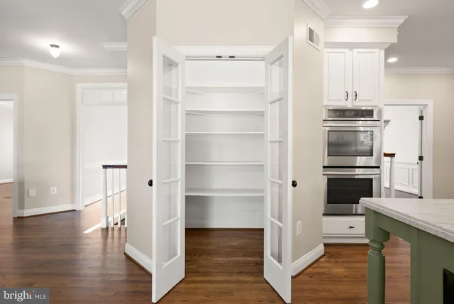 a view of a hallway with wooden floor and a fireplace