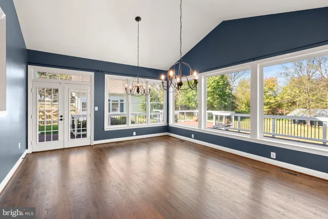 an empty room with a window and a ceiling fan