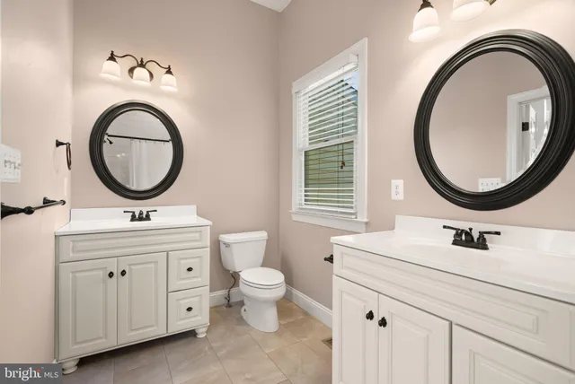 a spacious bathroom with a double vanity sink and a mirror