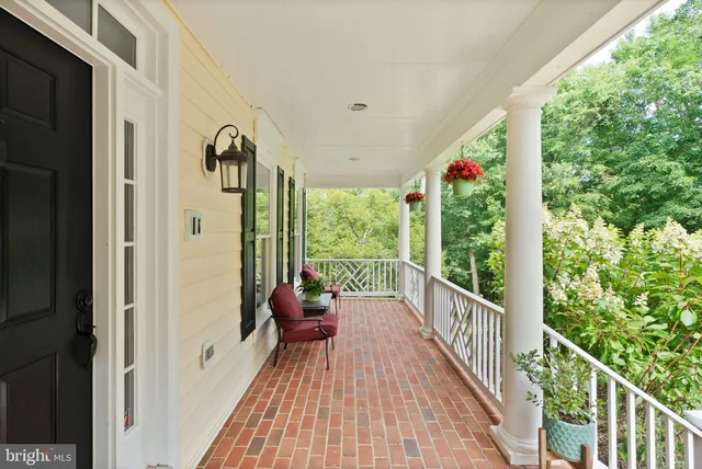 a large kitchen with kitchen island white cabinets and stainless steel appliances