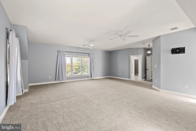 an aerial view of a houses with a lush green hillside