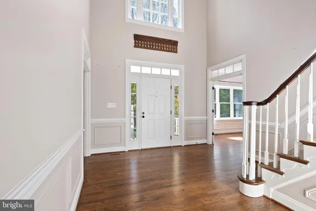 wooden floor fireplace and windows in an empty room