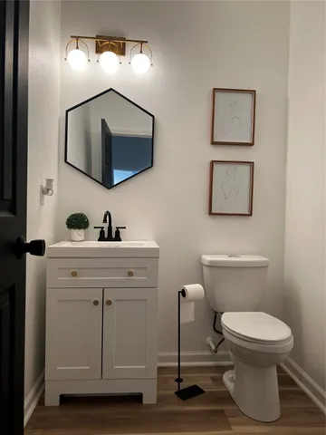 a bathroom with a toilet a sink and mirror