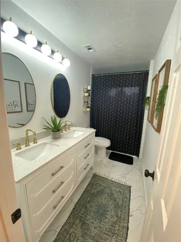 a bathroom with a double vanity sink and mirror