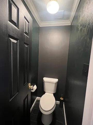 a white toilet sitting next to a bathroom sink