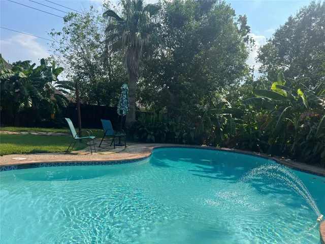 a view of a garden with swimming pool