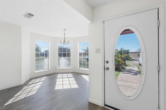 a view of an empty room with windows