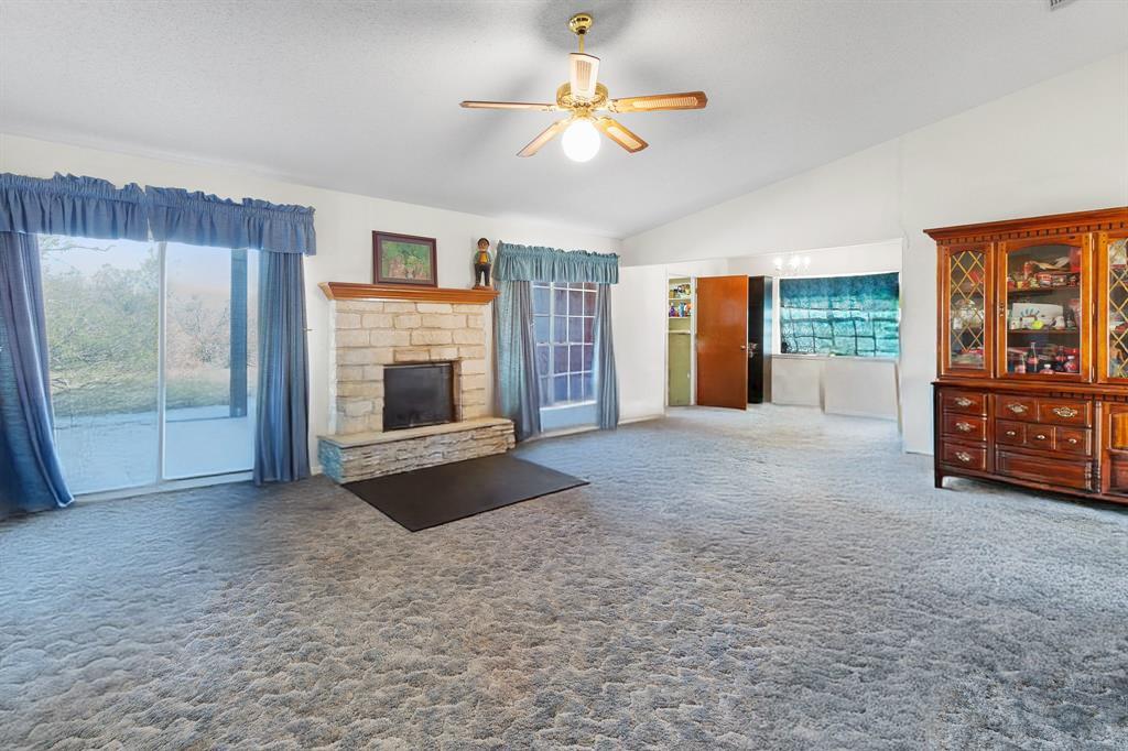 8548 Old Lockhart Road Buda, TX 78610 - Photo 6 of 19 a view of a livingroom with an empty space and a fireplace