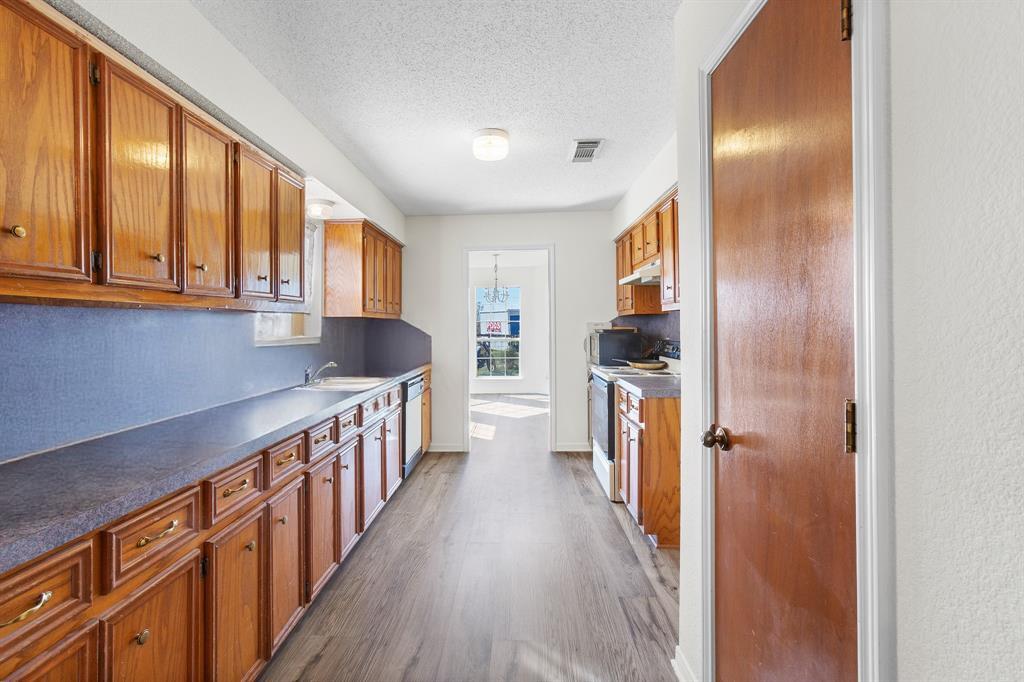 8548 Old Lockhart Road Buda, TX 78610 - Photo 8 of 19 a view of hallway with wooden floor and staircase