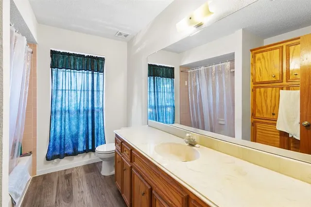 a bathroom with a tub sink and mirror