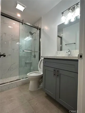 a bathroom with a toilet sink and shower