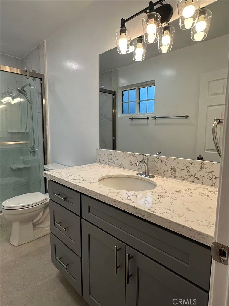 3044 Hodges Avenue Arcadia, CA 91006 - Photo 9 of 13 a bathroom with a granite countertop sink a toilet and a mirror