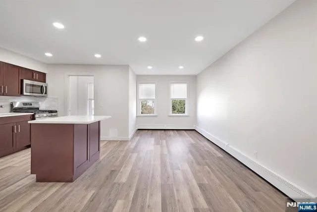 a view of kitchen with wooden floor and electronic appliances