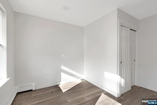 a view of an empty room and wooden floor