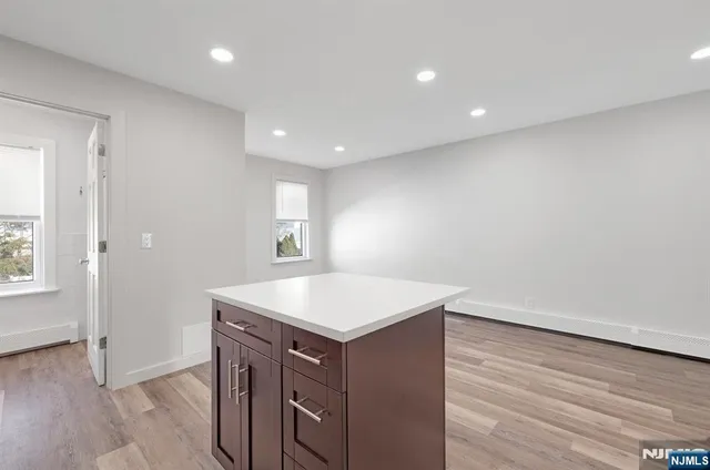 a kitchen with a sink cabinets and wooden floor