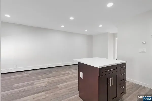 a kitchen with a sink cabinets and wooden floor