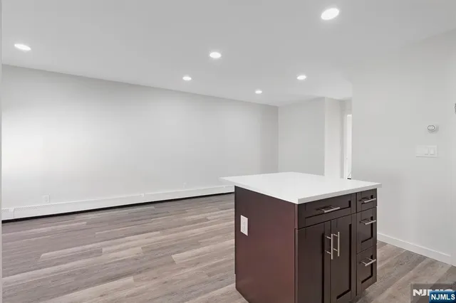 a kitchen with a sink cabinets and wooden floor