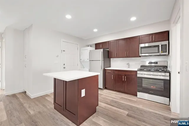a kitchen with a stove sink and a refrigerator