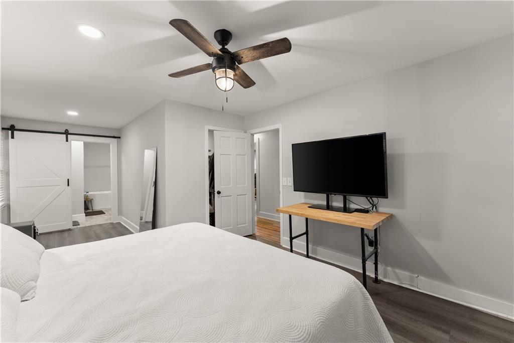 5907 Main Street Lula, GA 30554 - Photo 29 of 60 a bedroom with a bed and a flat screen tv