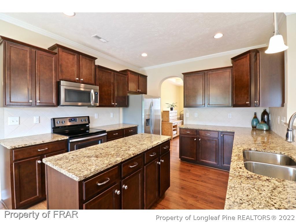 138 Culpepper Road Cameron, NC 28326 - Photo 11 of 30 a kitchen with stainless steel appliances granite countertop a sink stove microwave and refrigerator