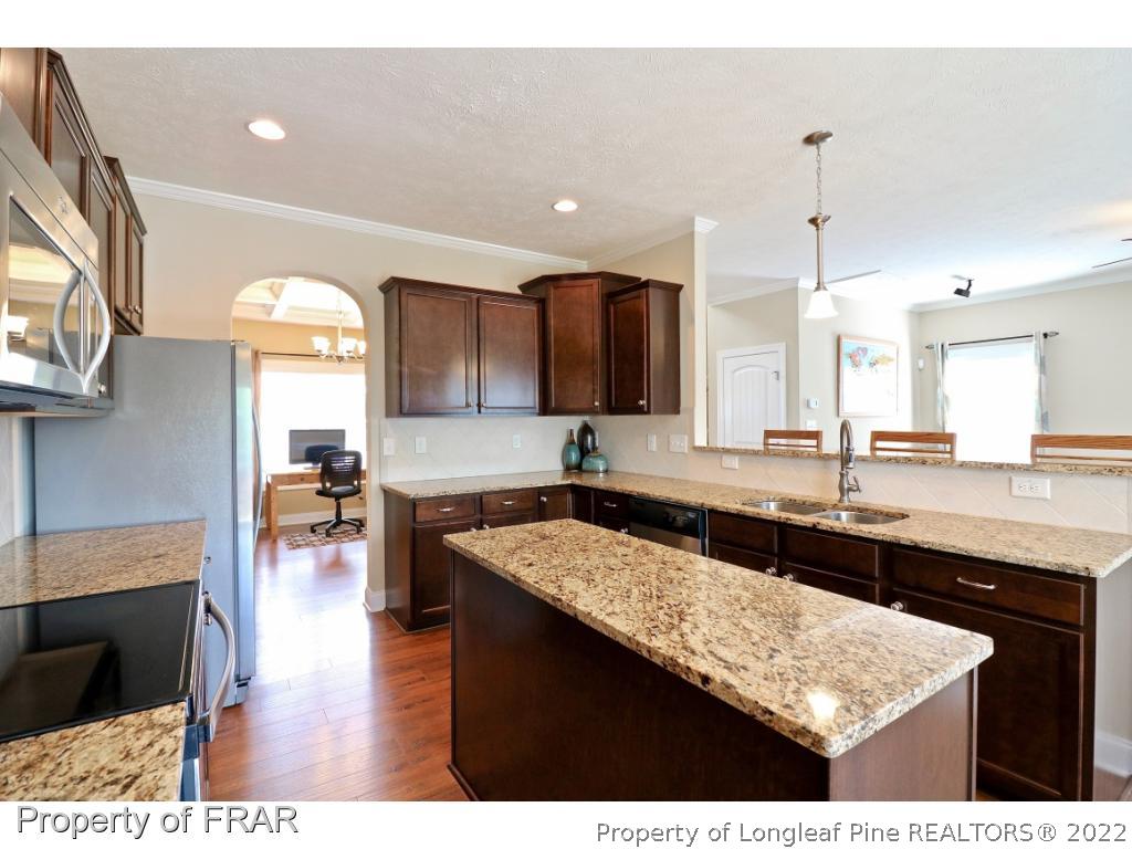 138 Culpepper Road Cameron, NC 28326 - Photo 12 of 30 a kitchen with counter top space sink and center island