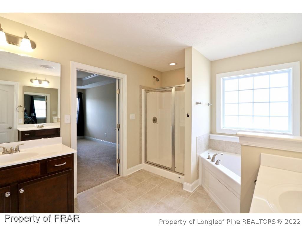 138 Culpepper Road Cameron, NC 28326 - Photo 23 of 30 a bathroom with a tub sink and a mirror