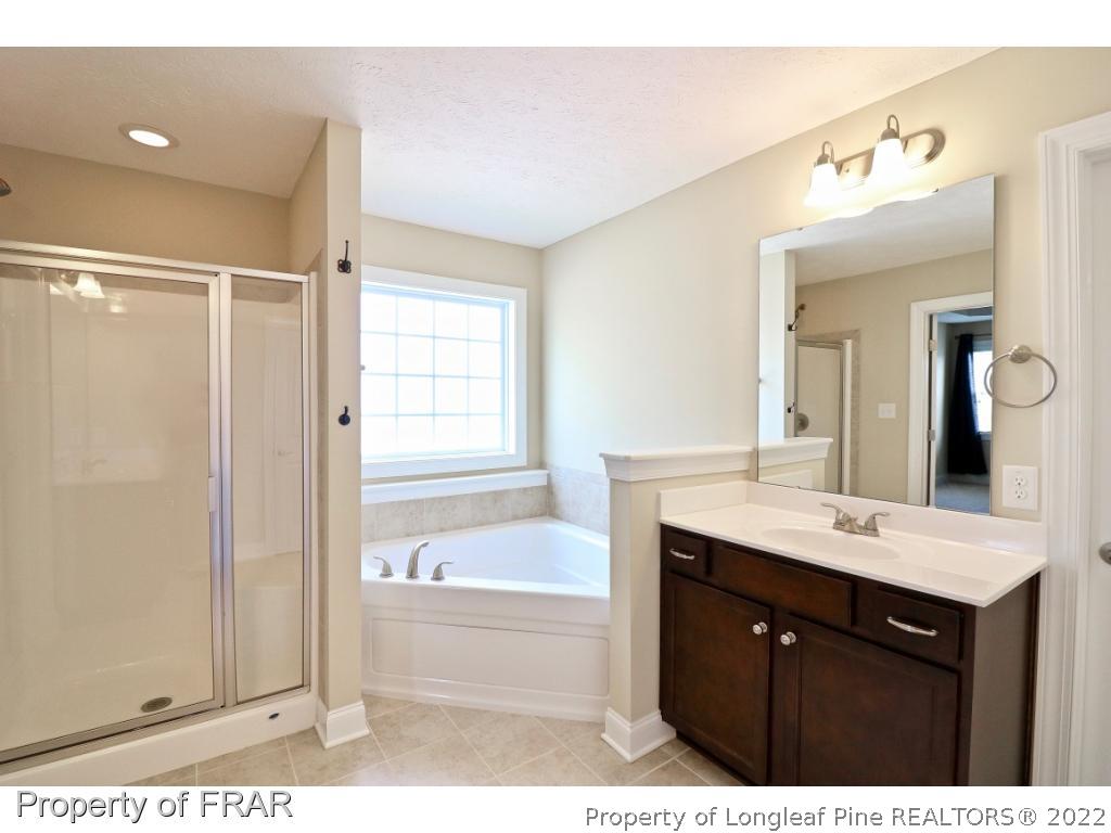 138 Culpepper Road Cameron, NC 28326 - Photo 24 of 30 a bathroom with a bathtub a sink and a mirror