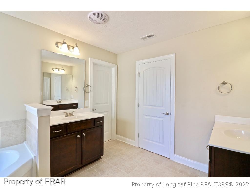 138 Culpepper Road Cameron, NC 28326 - Photo 25 of 30 a bathroom with a sink vanity and mirror