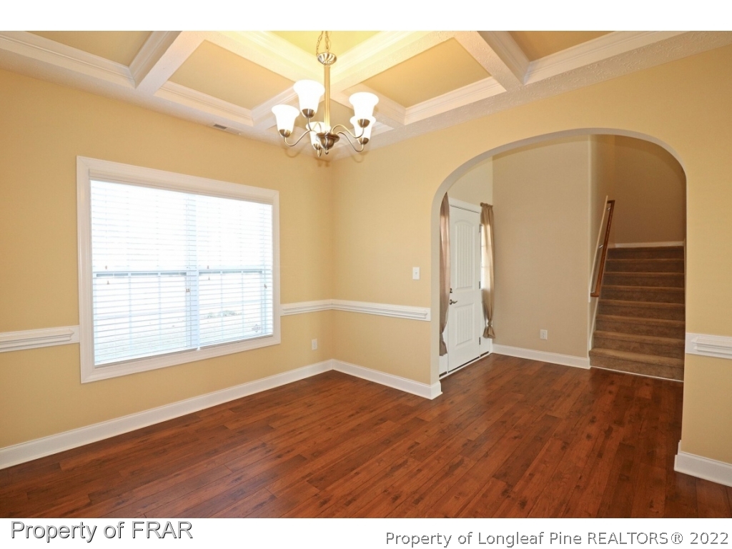 138 Culpepper Road Cameron, NC 28326 - Photo 4 of 30 an empty room with wooden floor chandelier and windows