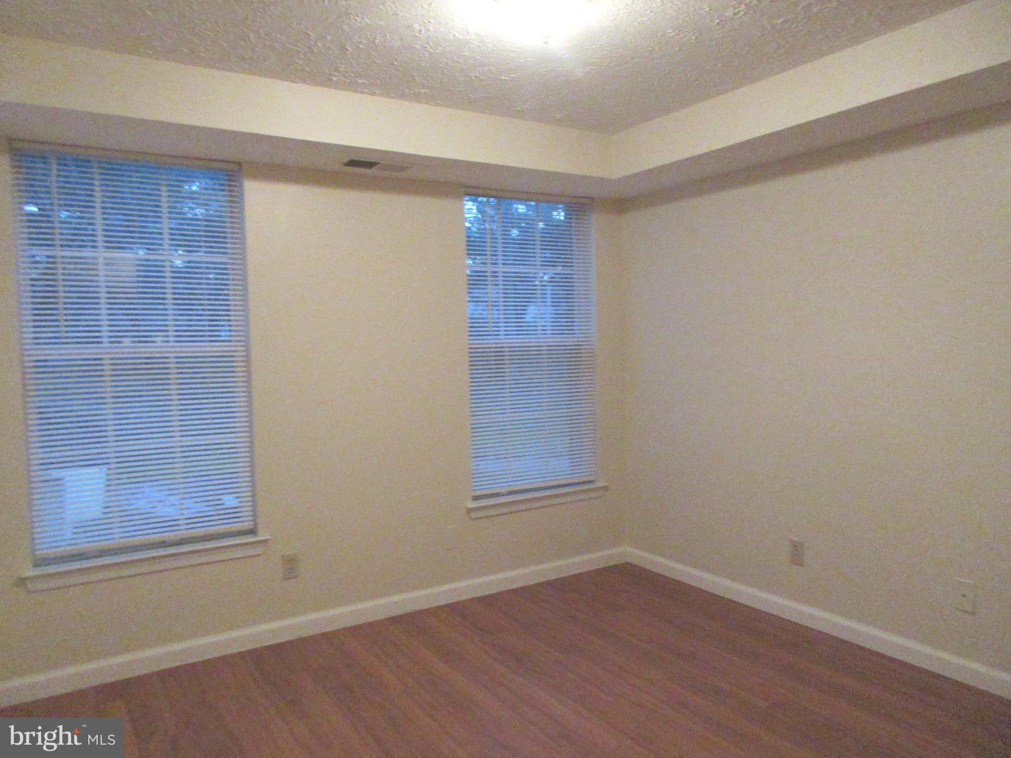87 Eldon Way Marlton, NJ 08053 - Photo 13 of 22 a view of an empty room with wooden floor and a window