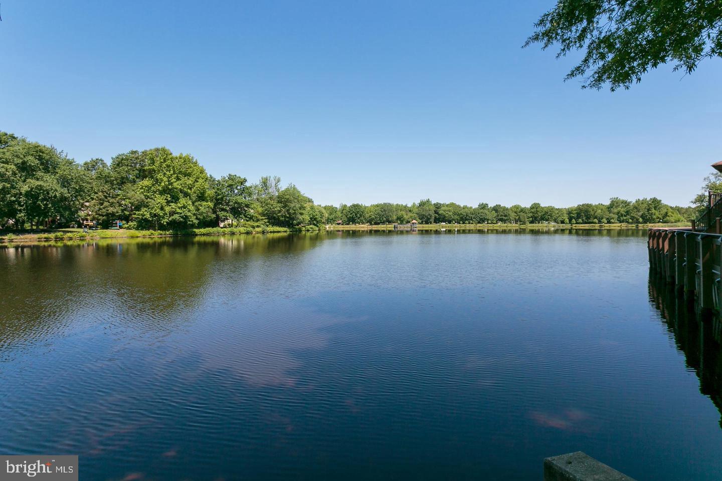 87 Eldon Way Marlton, NJ 08053 - Photo 22 of 22 a view of a lake with houses in the background