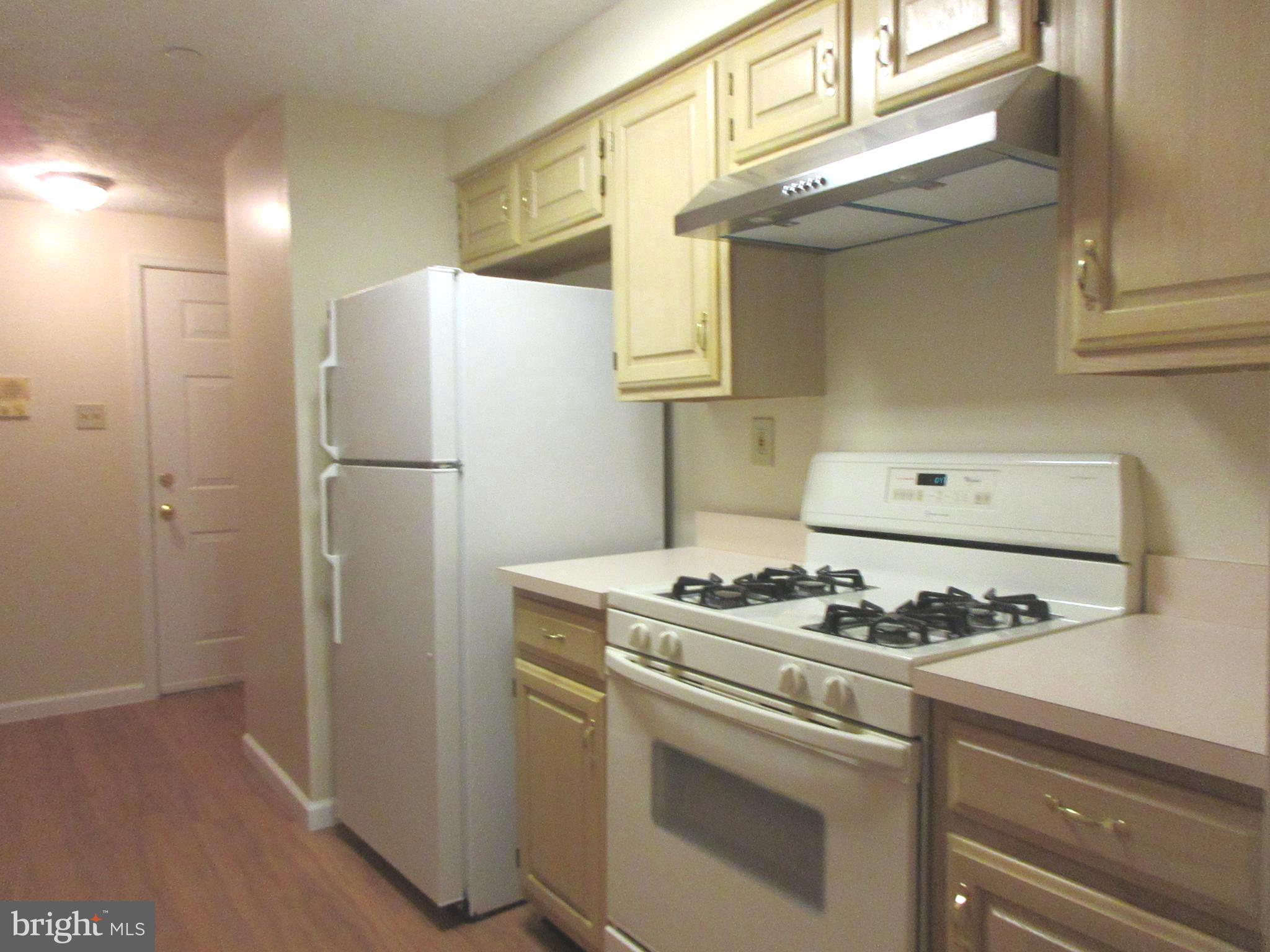 87 Eldon Way Marlton, NJ 08053 - Photo 5 of 22 a white refrigerator freezer and a stove sitting inside of a kitchen