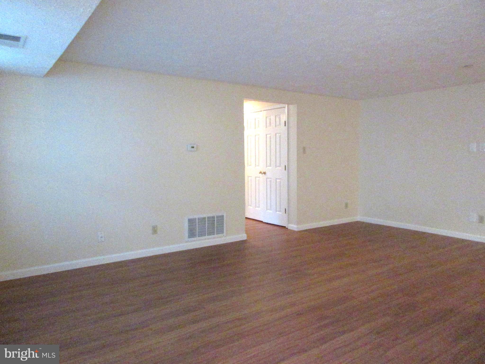 87 Eldon Way Marlton, NJ 08053 - Photo 8 of 22 a view of an empty room with wooden floor and windows