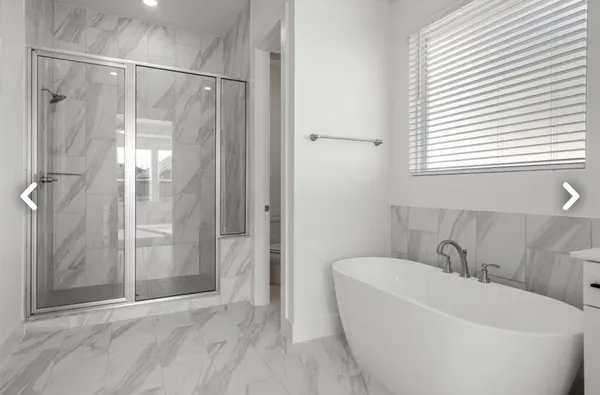 a bathroom with a tub sink and mirror