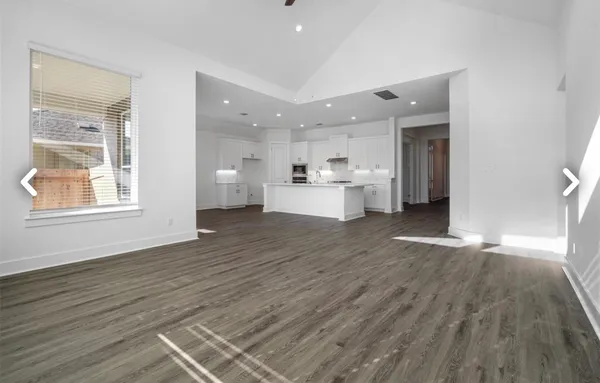 a view of kitchen with cabinets microwave and stove