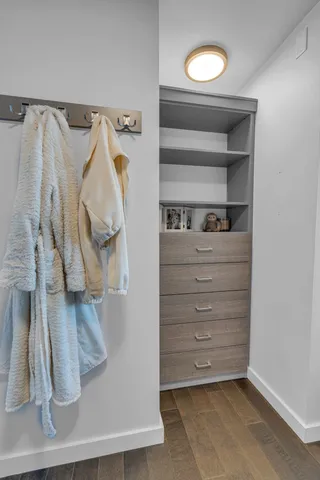 a view of walk in closet with clothes and shoes