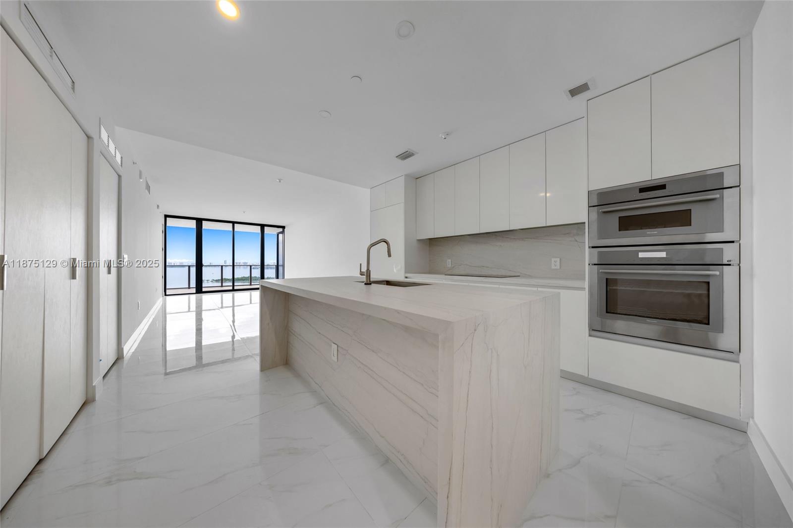 700 Northeast 24th Street, Unit 1706 Miami, FL 33137 - Photo 12 of 95 a kitchen with stainless steel appliances granite countertop a stove a sink and a refrigerator