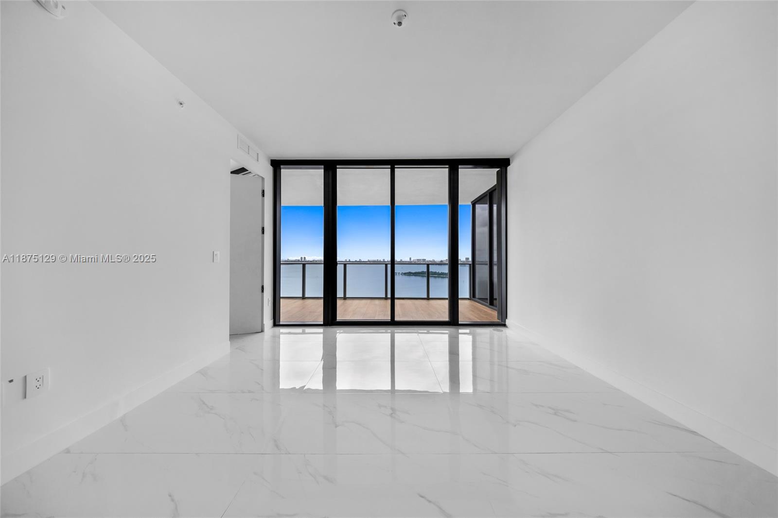 700 Northeast 24th Street, Unit 1706 Miami, FL 33137 - Photo 16 of 95 wooden floor in an empty room with a window