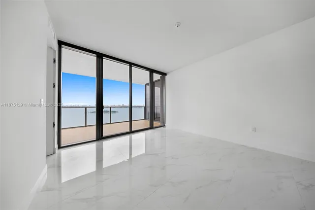 a large white kitchen with a large window