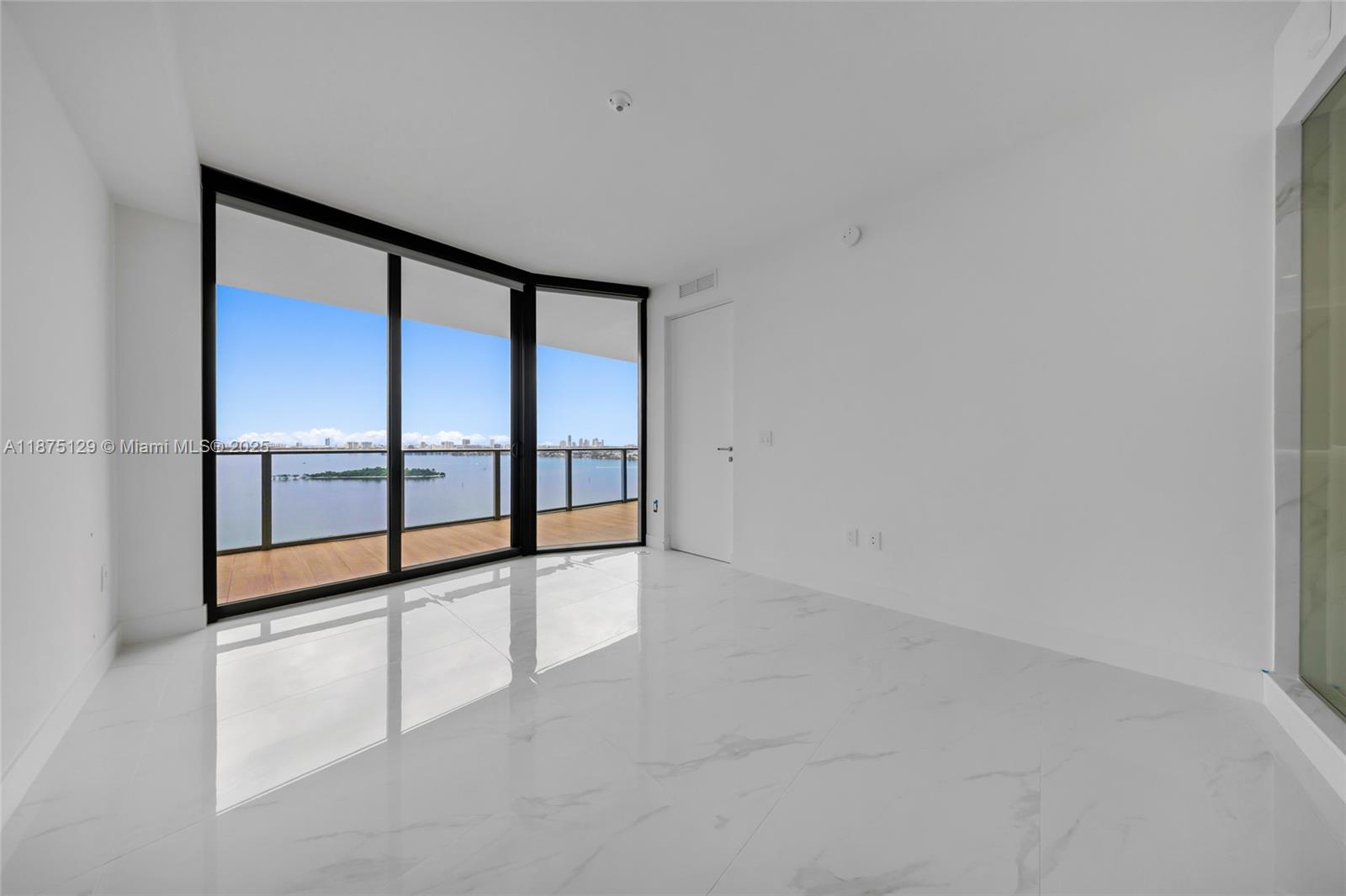 700 Northeast 24th Street, Unit 1706 Miami, FL 33137 - Photo 23 of 95 wooden floor in an empty room with a window