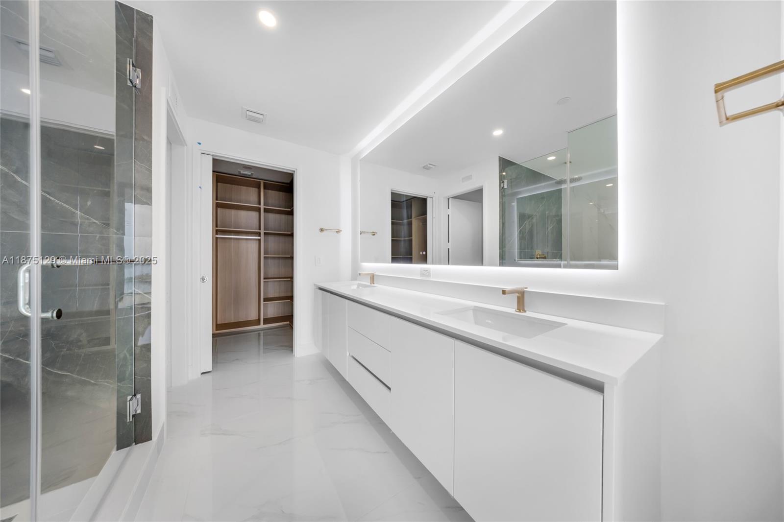 700 Northeast 24th Street, Unit 1706 Miami, FL 33137 - Photo 31 of 95 a bathroom with a double vanity sink mirror and shower