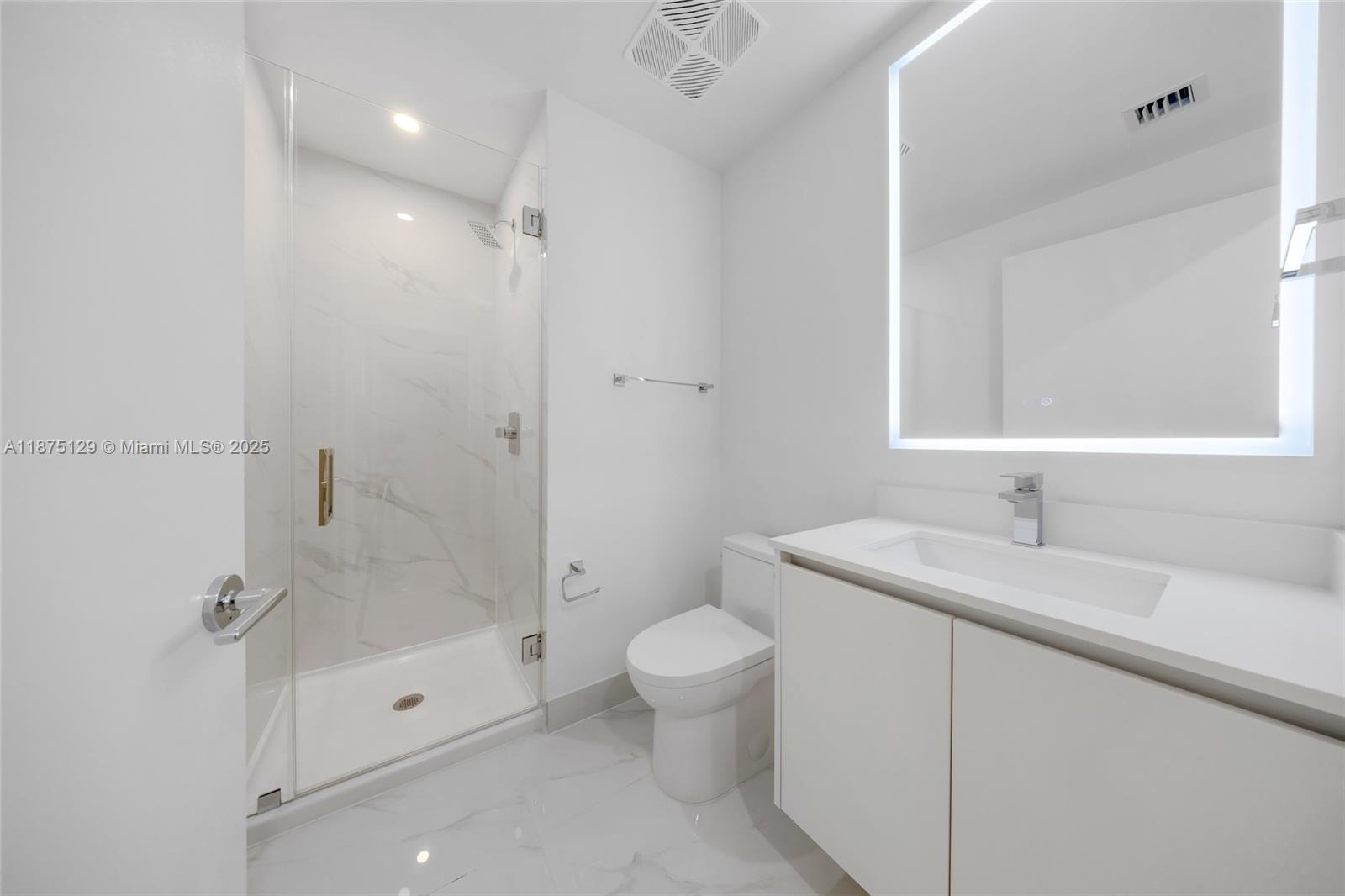 700 Northeast 24th Street, Unit 1706 Miami, FL 33137 - Photo 34 of 95 a bathroom with a granite countertop sink a toilet and shower