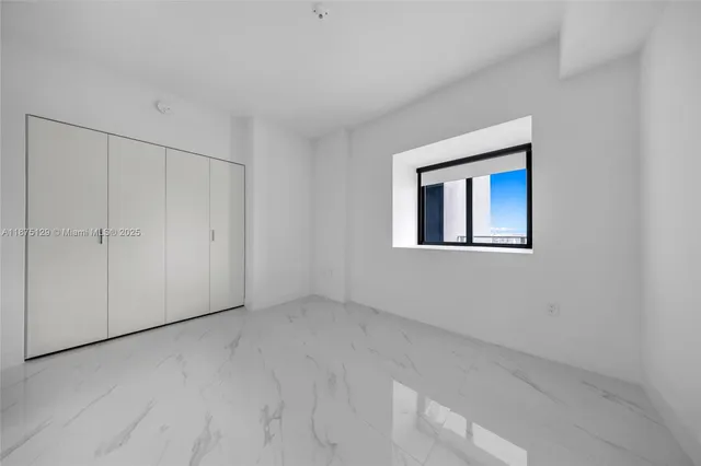 a room with lots of furniture and potted plants