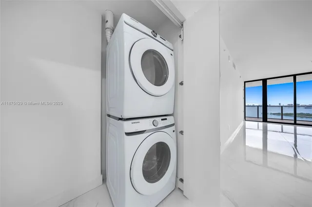 a room with gym equipment and large windows