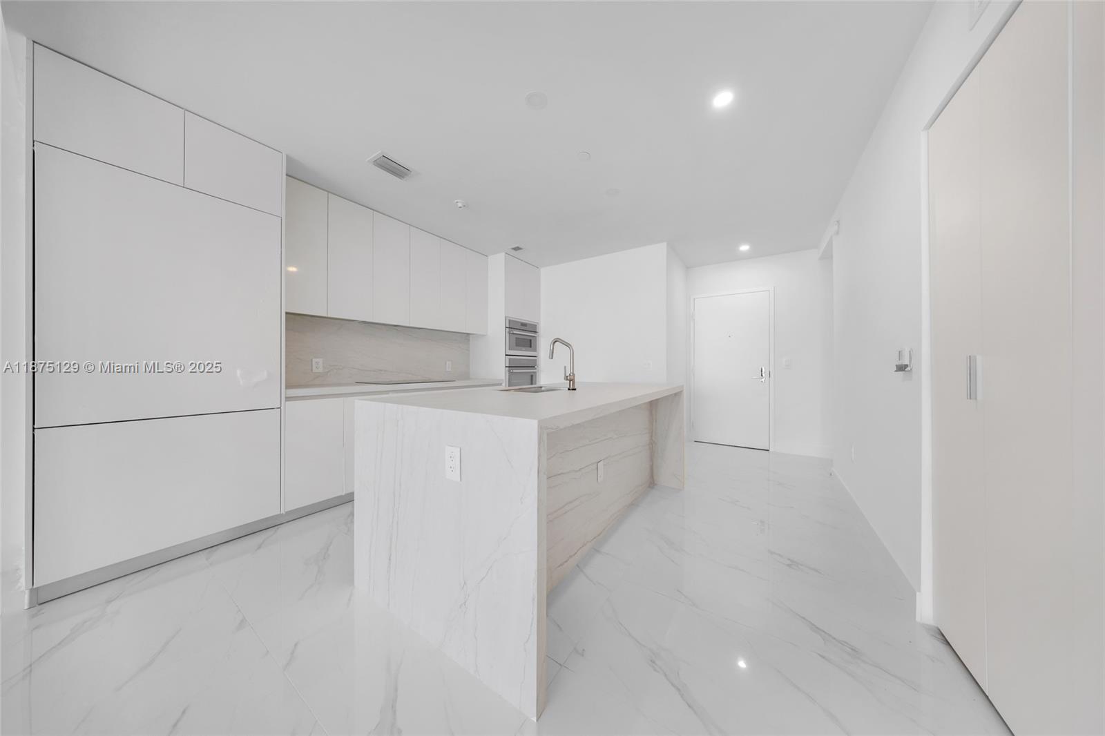 700 Northeast 24th Street, Unit 1706 Miami, FL 33137 - Photo 10 of 95 a view of a kitchen with white cabinets