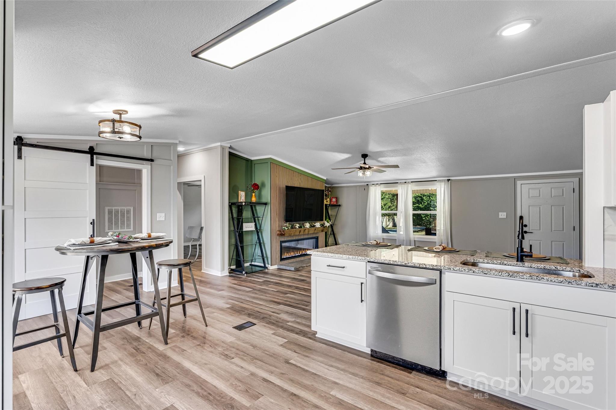 4881 Grassy Creek Road Denver, NC 28037 - Photo 11 of 25 a kitchen with a sink cabinets and dining table chair