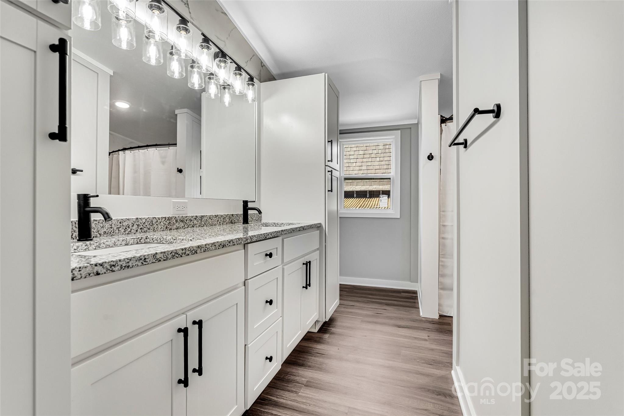 4881 Grassy Creek Road Denver, NC 28037 - Photo 16 of 25 a spacious bathroom with a granite countertop sink mirror and a shower