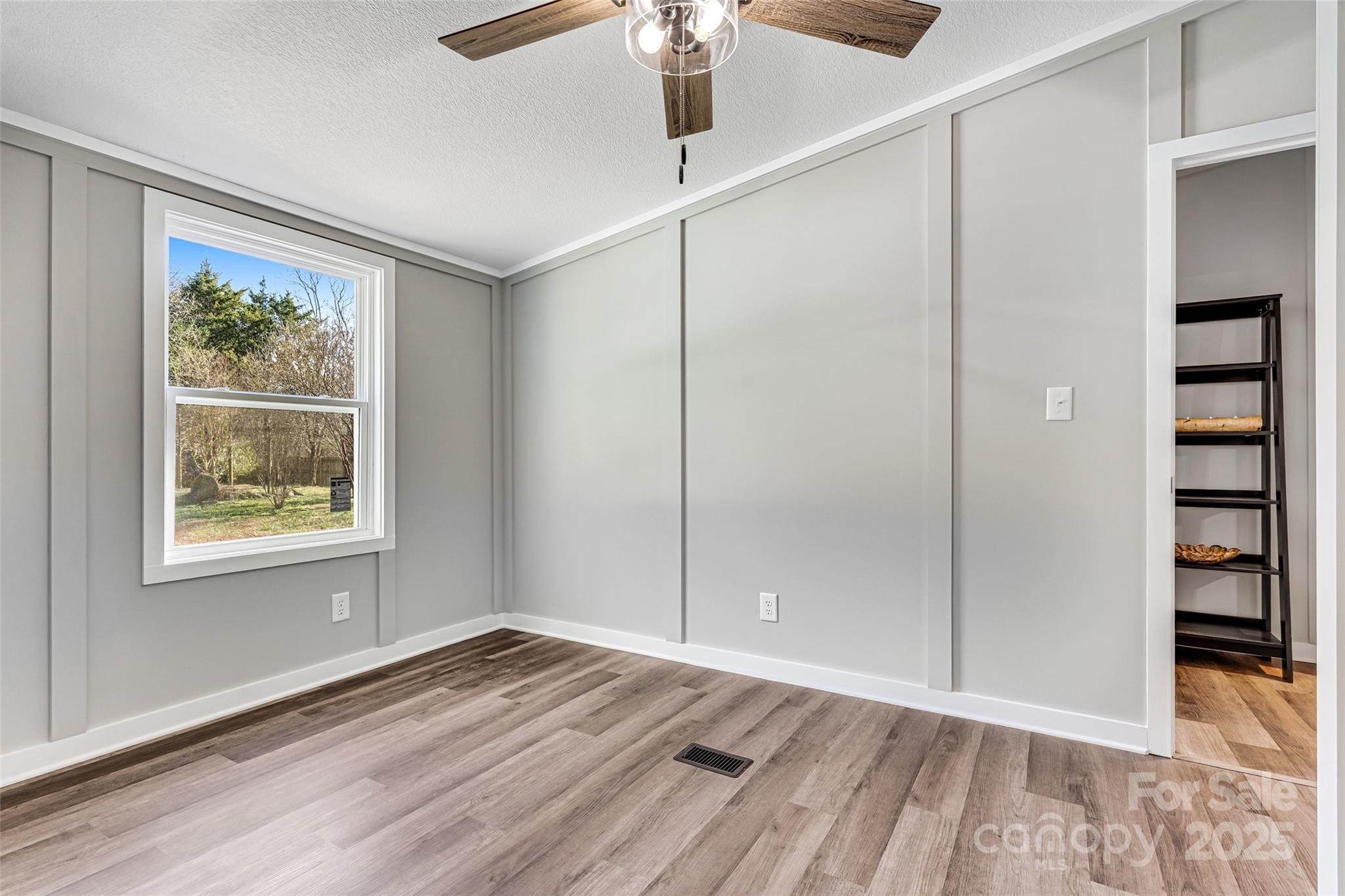 4881 Grassy Creek Road Denver, NC 28037 - Photo 23 of 25 a view of an empty room with window and wooden floor