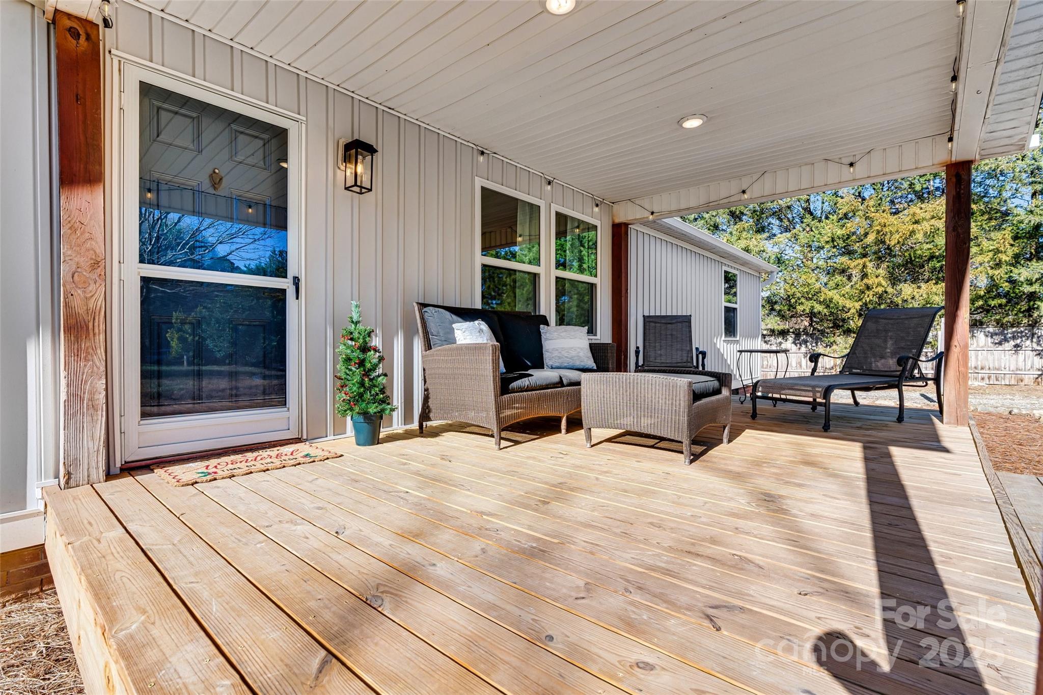 4881 Grassy Creek Road Denver, NC 28037 - Photo 4 of 25 a view of a patio with table and chairs potted plants with floor to ceiling window