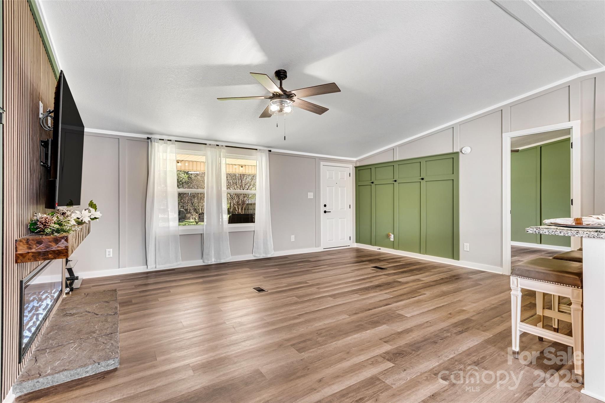 4881 Grassy Creek Road Denver, NC 28037 - Photo 8 of 25 a view of an empty room with a window and wooden floor